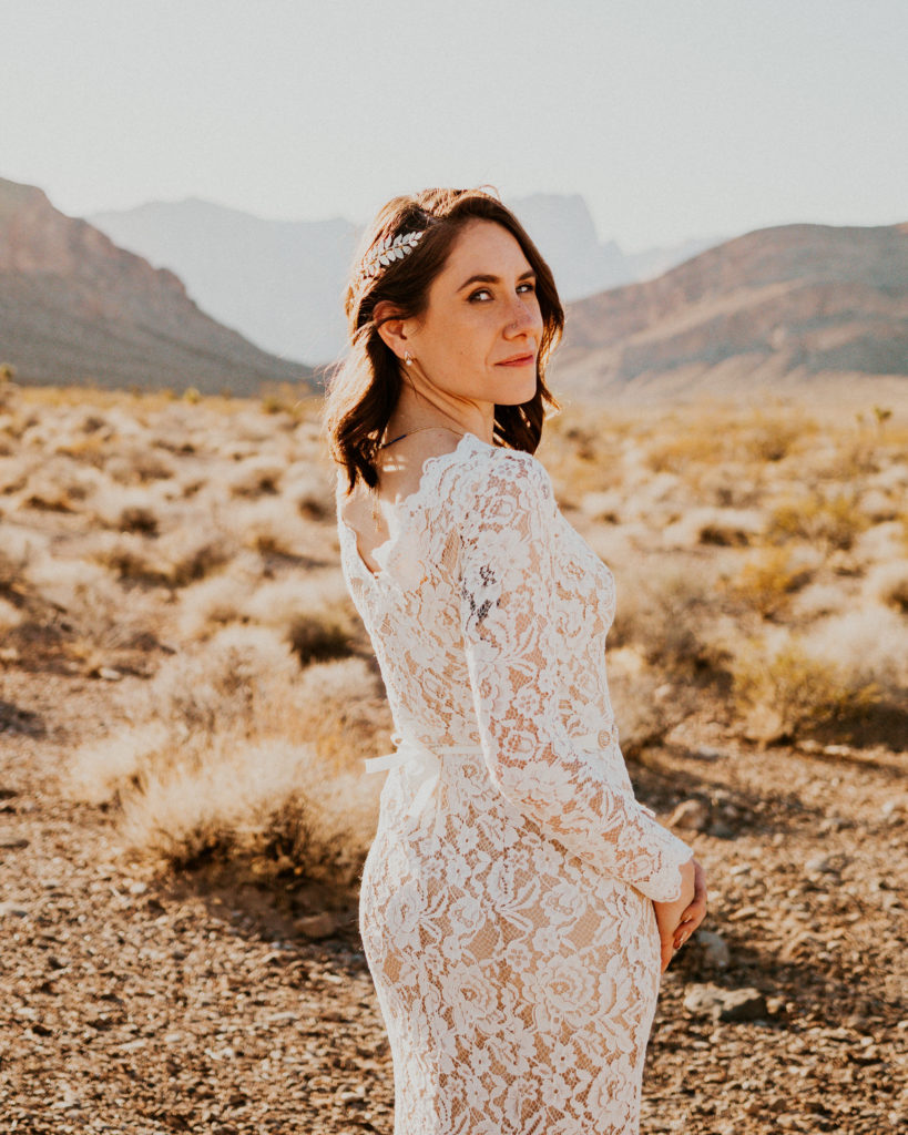 What is a boho style wedding. Beautiful bride in a boho style wedding dress. Long sleeve white lace dress with a skinny white belt. A jeweled hair that clips into her side braid. 