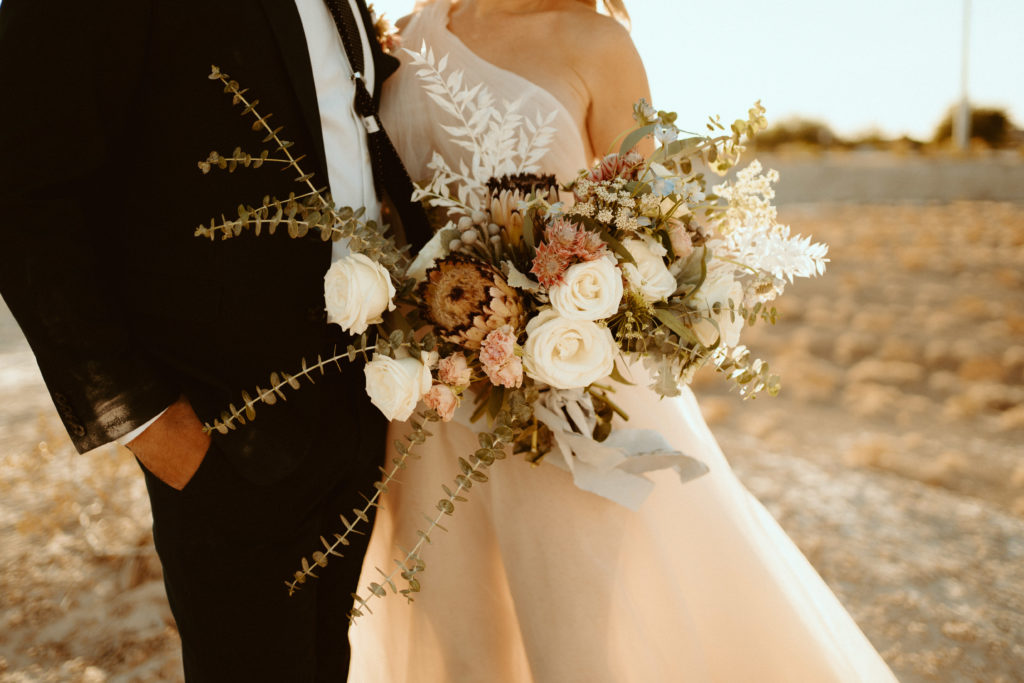 What is a Rustic & Whimsical Styled Wedding? Rustic and whimsical style bridal bouquet with different colored roses and eucalyptus 