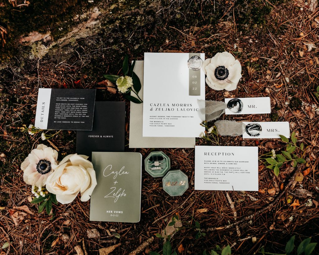 What is a Rustic & Whimsical Styled Wedding? Modern wedding stationary in a rustic background with colors of sage green, taupe and black with flowers and mulch. 