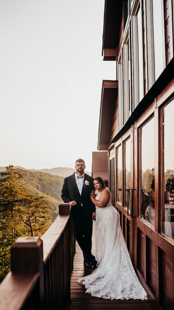 Newlyweds on the patio of a modern barn at the magnolia venue surrounded in the smokey mountains. 