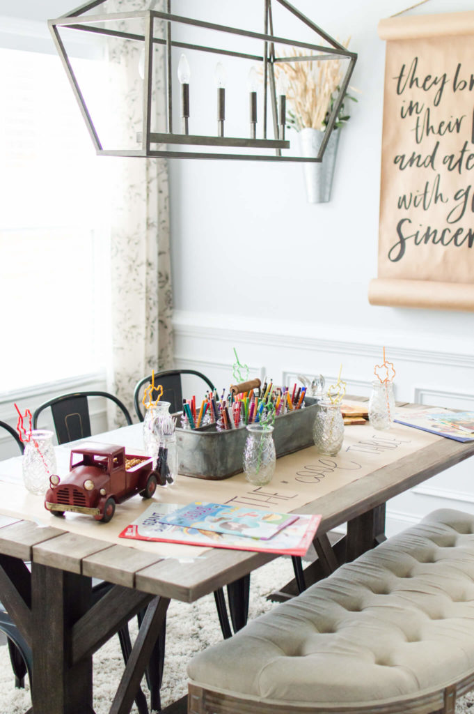 How to style the perfect thanksgiving table! Farmhouse style kids table for thanksgiving. Colored pencils and markers in a cute rustic bin in the middle of the table. Coloring books for each kid at the table with cute thanksgiving design bendy straws. 