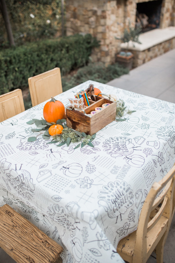 How to style the perfect thanksgiving table! Fun and creative kids table for thanksgiving. Color friendly table cloth with crayons, markers and stickers for each kid. 