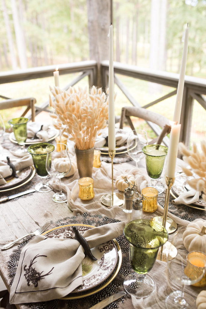 How to style the perfect thanksgiving table! Muted colored goblets, bunny tails and detailed plates with feather chargers. 