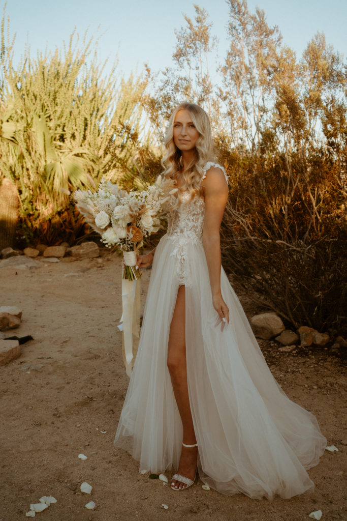 What is a Timeless & Romantic Styled Wedding. Flowy and lace bridal gown on bride in the middle of the desert at Joshua Tree. 