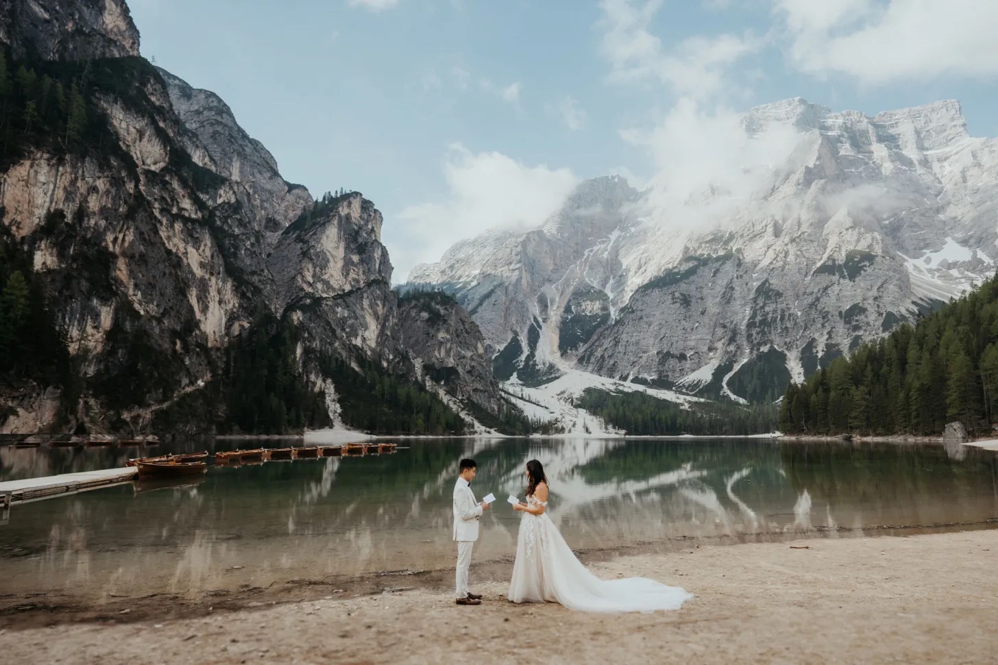 Couple reading vows with lake and snowy mountains behind them. 5 Rules when it comes to Planning a Wedding close to the Holidays