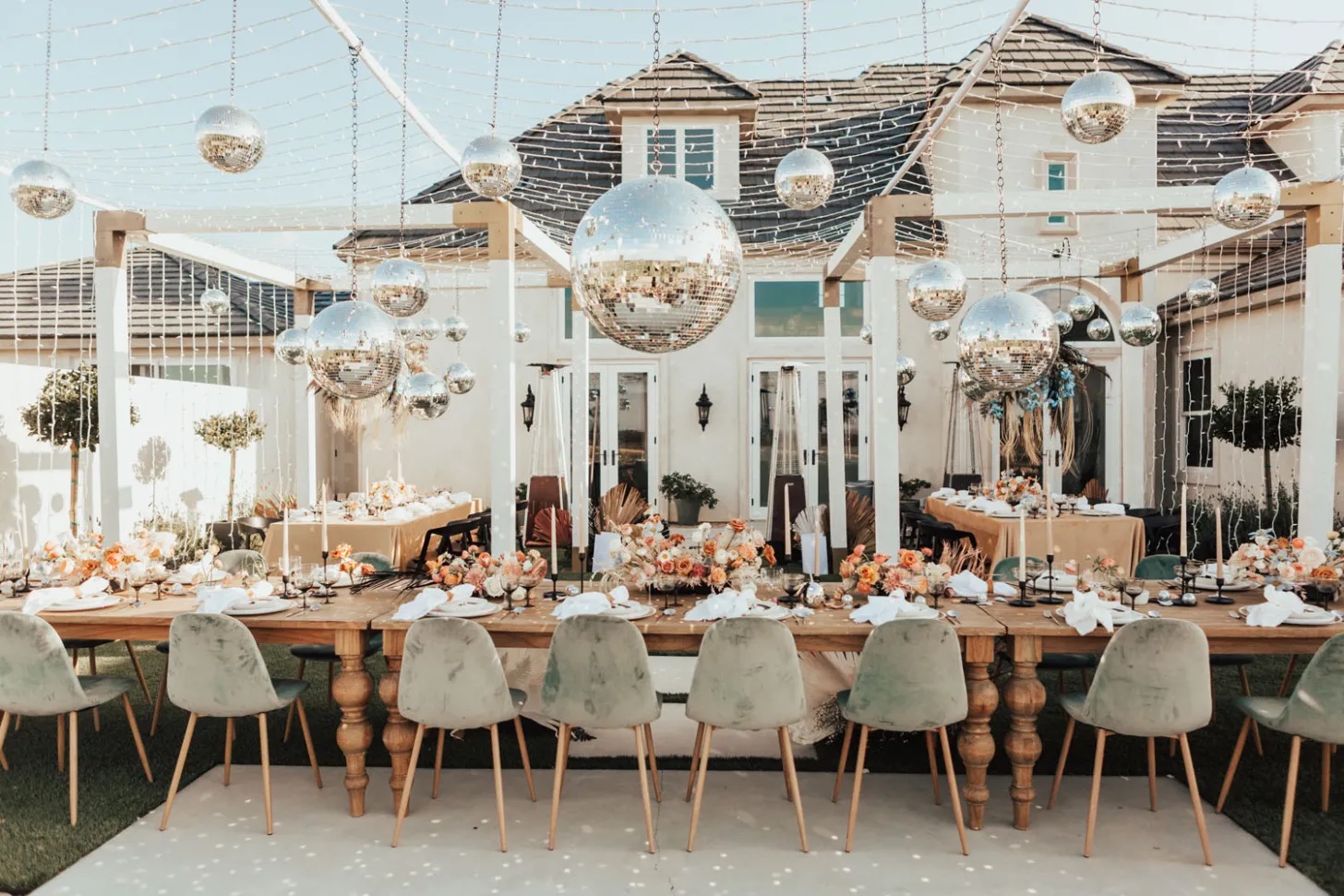 The Official List of 2023 Wedding Trends! Disco ball and twinkle light hanging instillation over the entire reception.