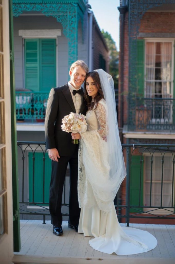 Newlyweds standing on the balcony in the French Quarters
