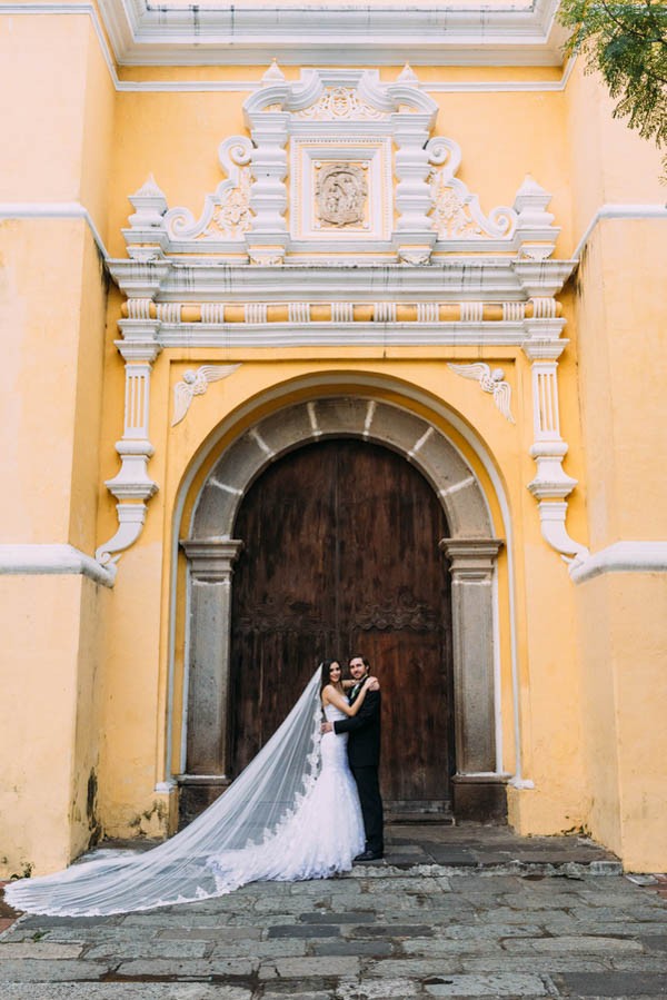Top 10 Destination Wedding Locations for 2023! Newlyweds pose in front of a historical church in Guatemala