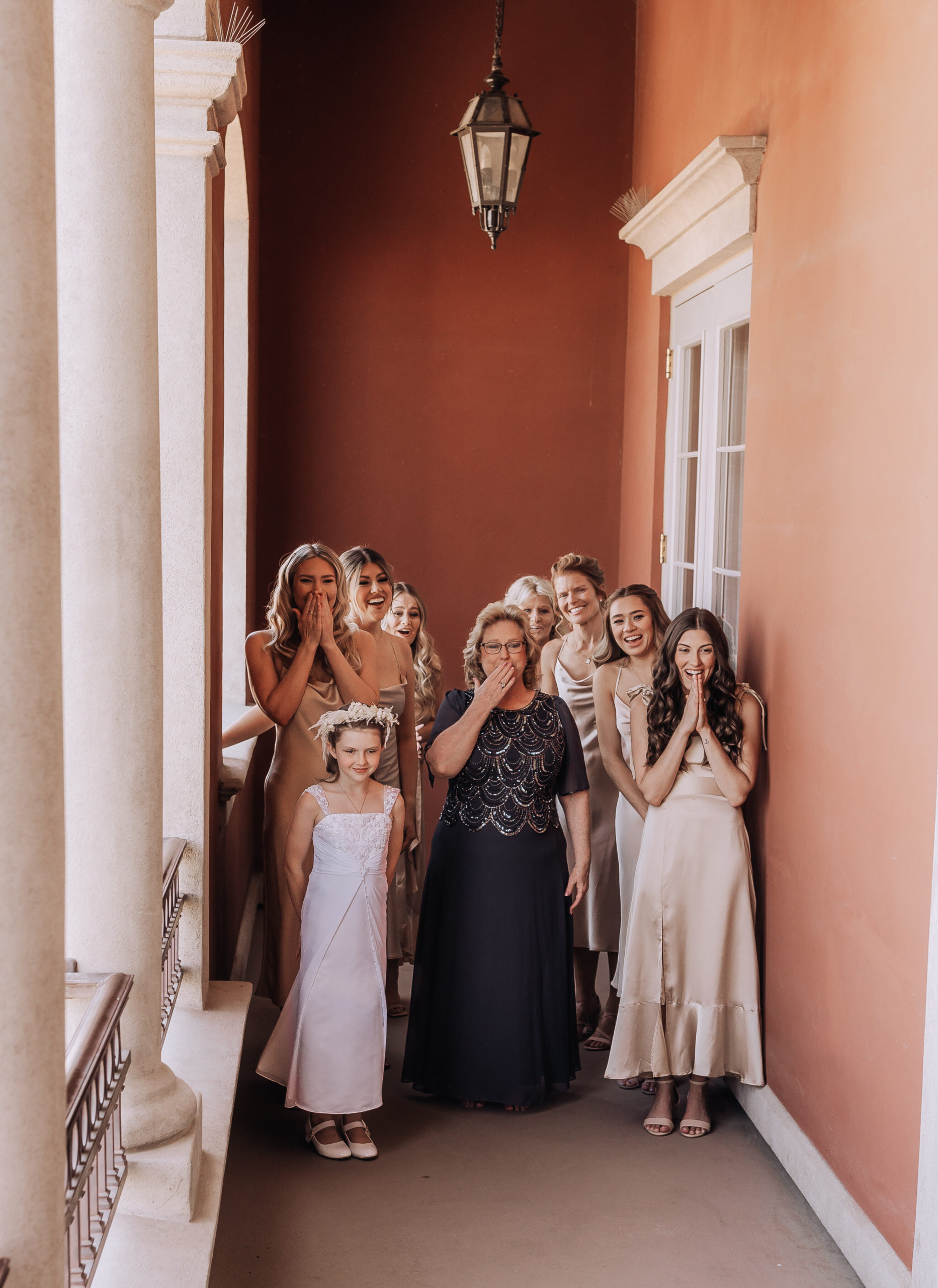 The bridal party and mother of the bride in awe of the bride 