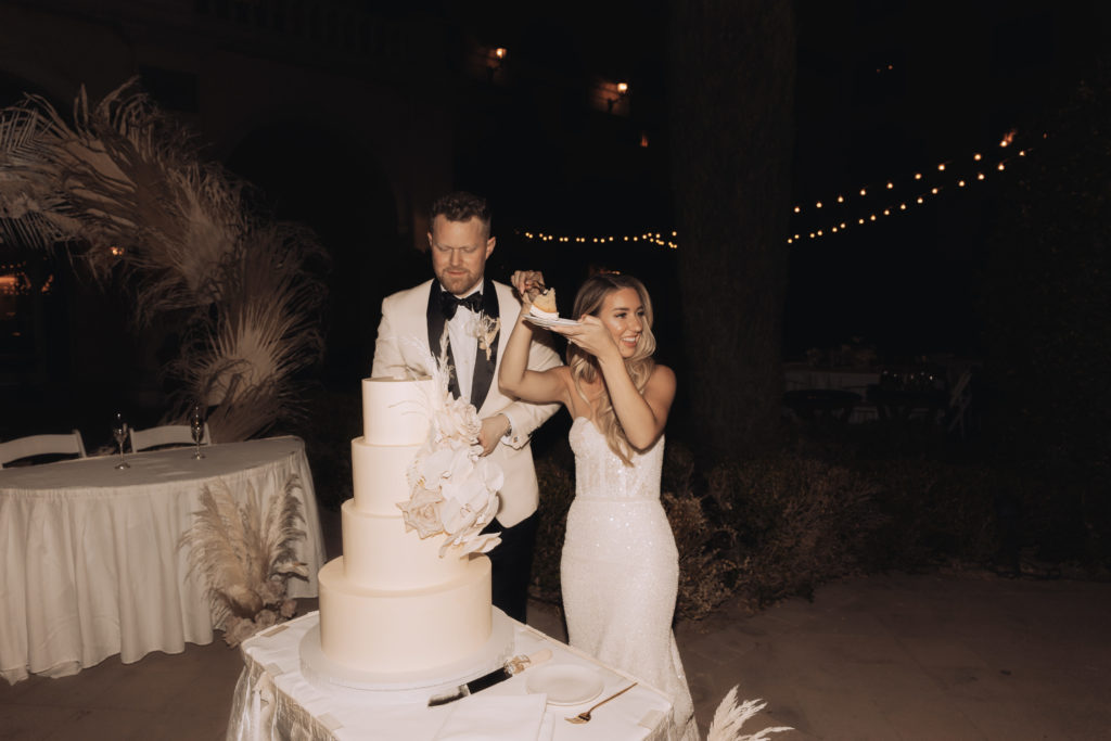 Lake Las Vegas Meets Modern Boho Bride. Newlywed cut wedding cake