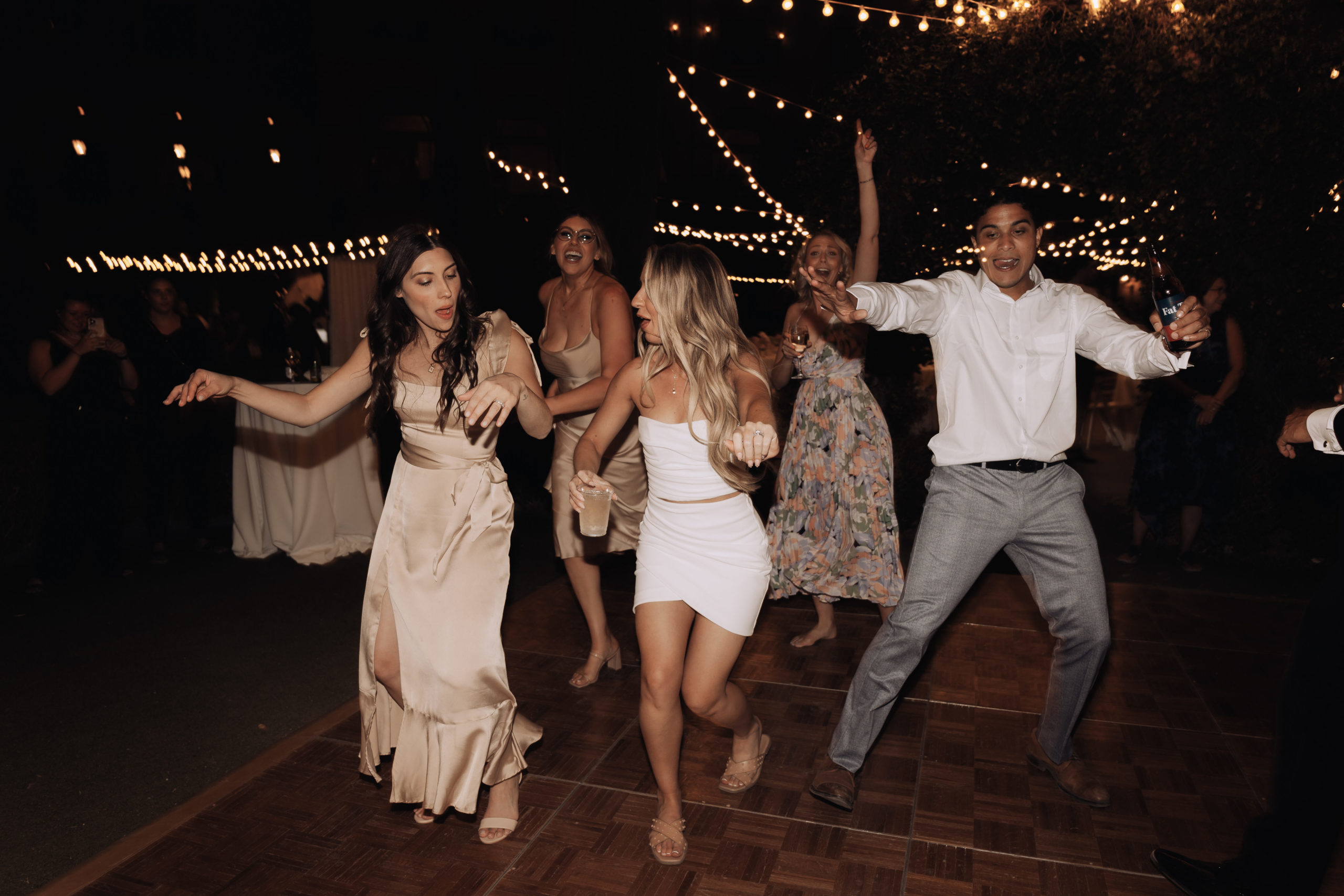 Lake Las Vegas Meets Modern Boho Bride. Bride dancing with bridesmaid and guest 