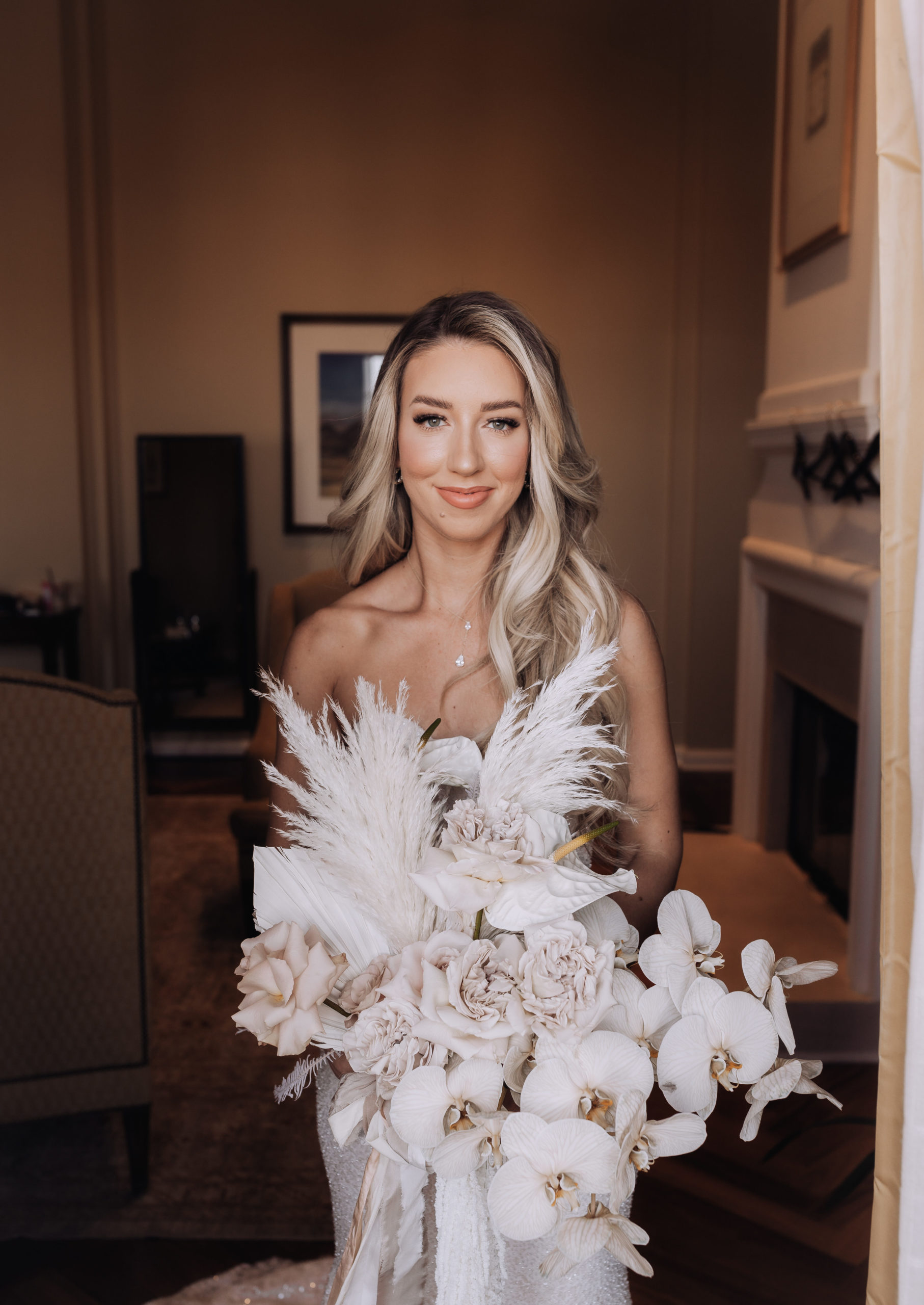Lake Las Vegas Meets Modern Boho Bride. The beautiful bride standing in the doorway of the bridal suit ready to reveal her gorgeous lace corset wedding dress to her bridal party