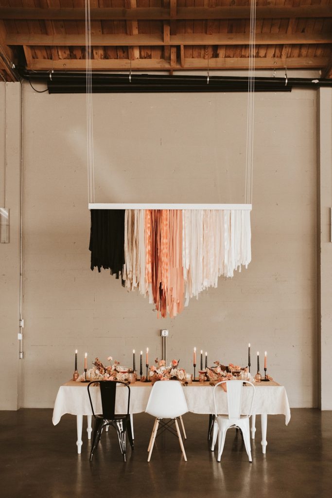 Custom made macrame hanging above micro wedding reception table 