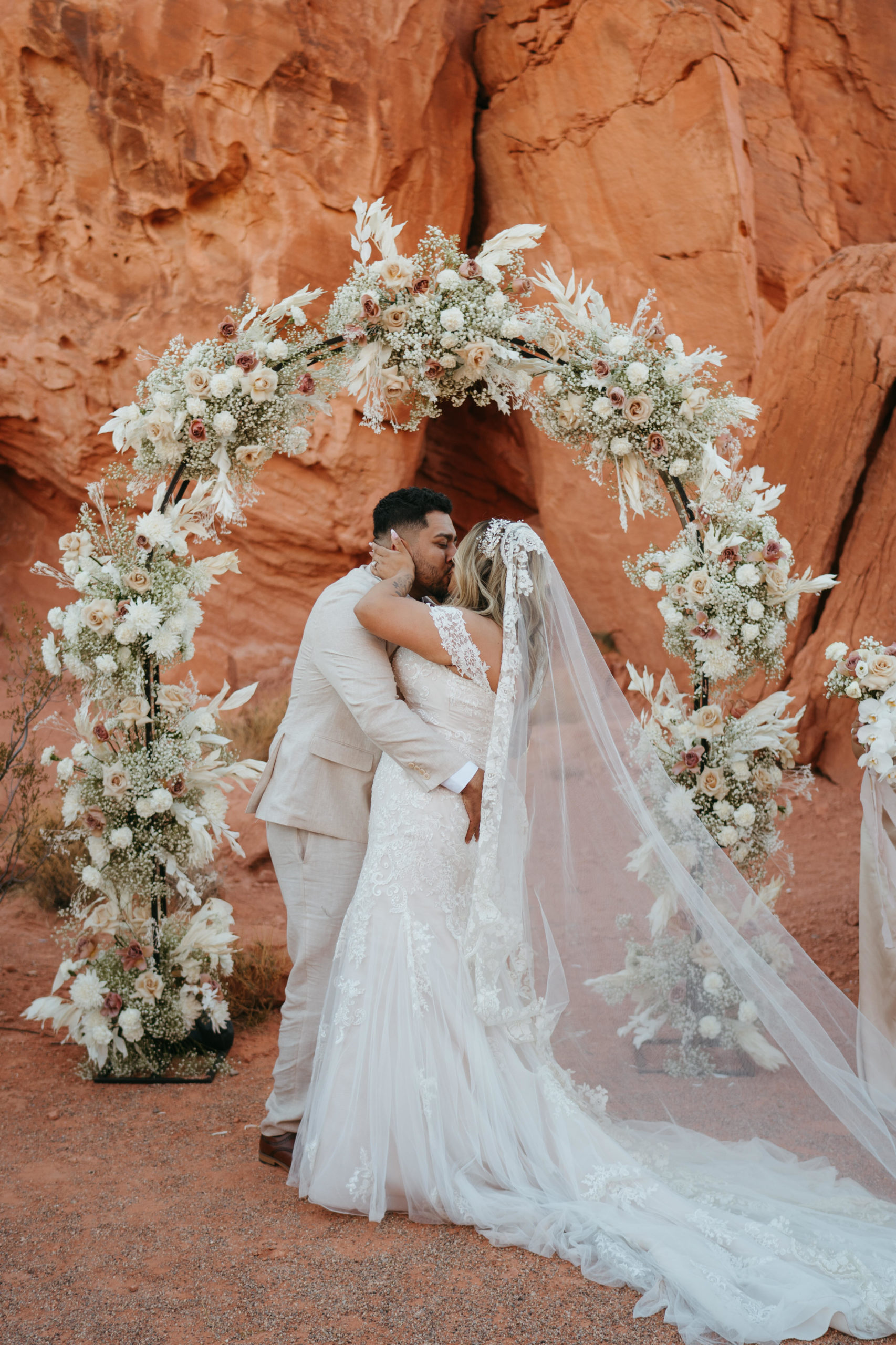 Modern Monochromatic Desert Micro-Wedding. The first kiss as Mr. and Mrs. 