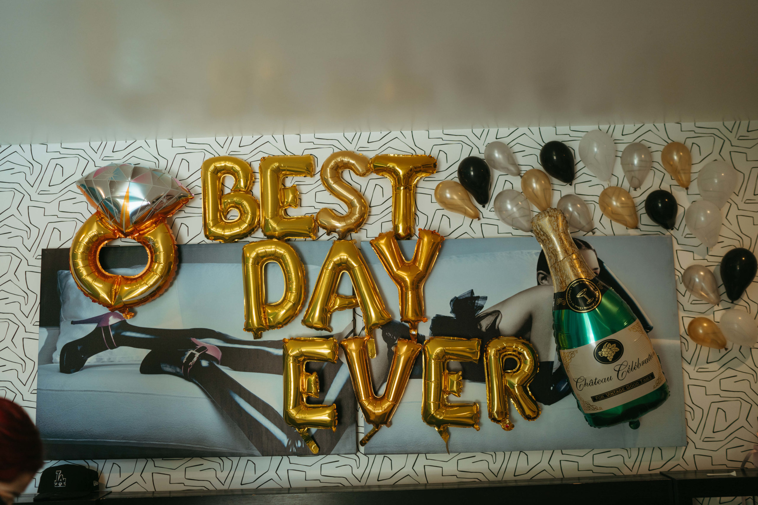 Best Day Ever balloons placed on airbnb wall
