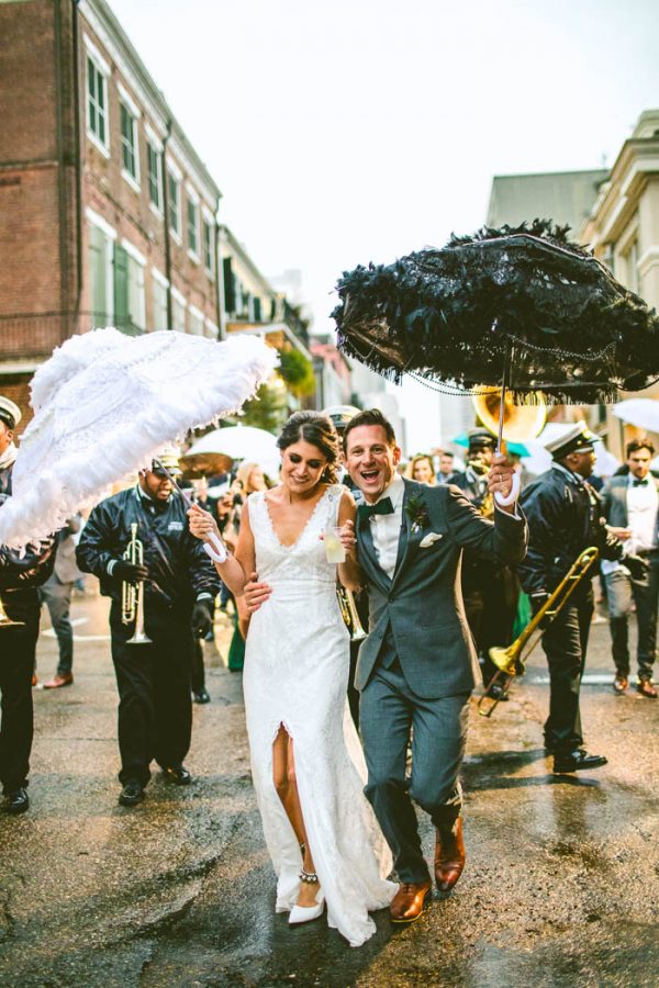 Newlyweds leading a second line parade on the streets of New Orleans