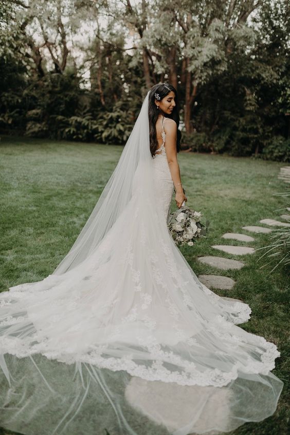 Bride in the garden wearing a cathedral veil