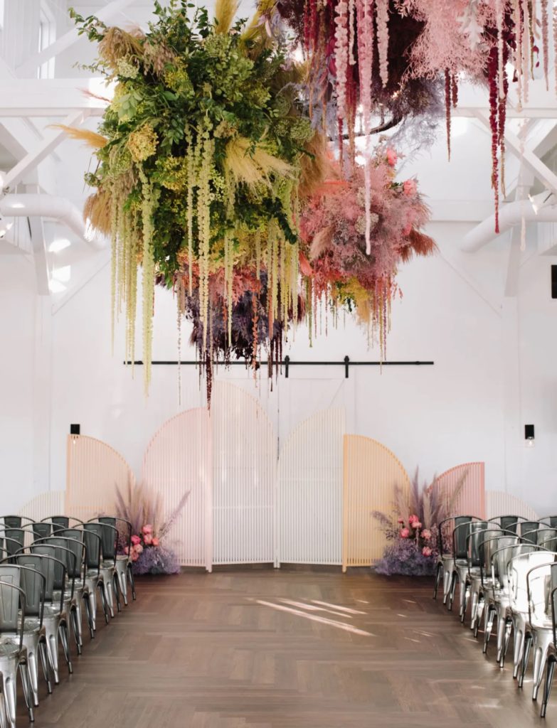  Colorful hanging florals above the aisle for ceremony 