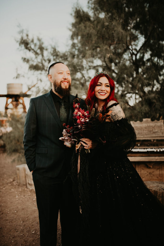 Couple in all black and moody bouquet for halloween elopement 