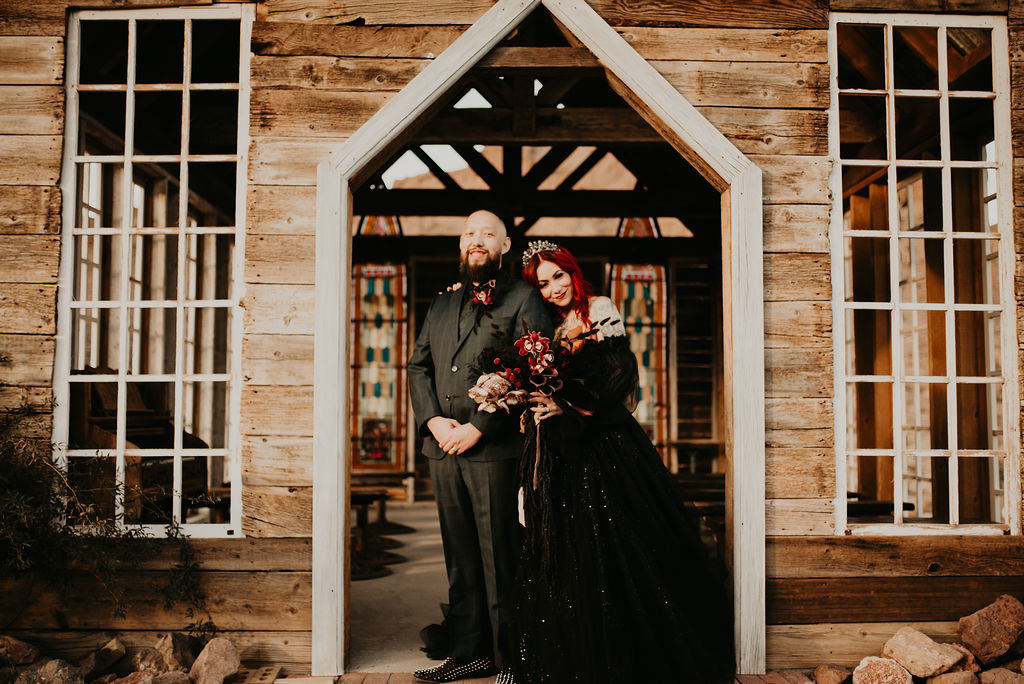 Bride and Groom standing in doorway of Nelson's Ghost Town Chapel just outside of Las Vegas on Halloween 