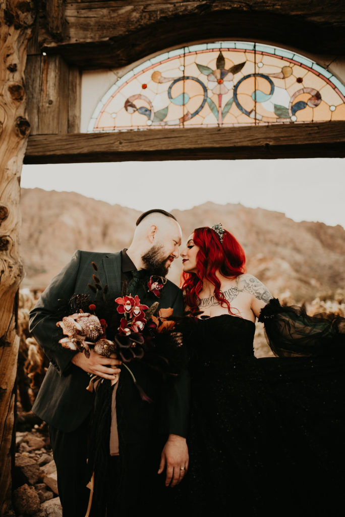 Newlyweds standing under mosaic sign at Nelson's Ghost Town 