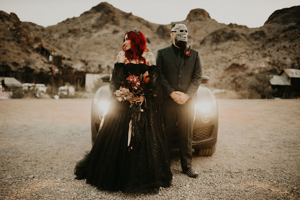 Groom in mask with Bride for Halloween Elopement at Nelson's Ghost Town