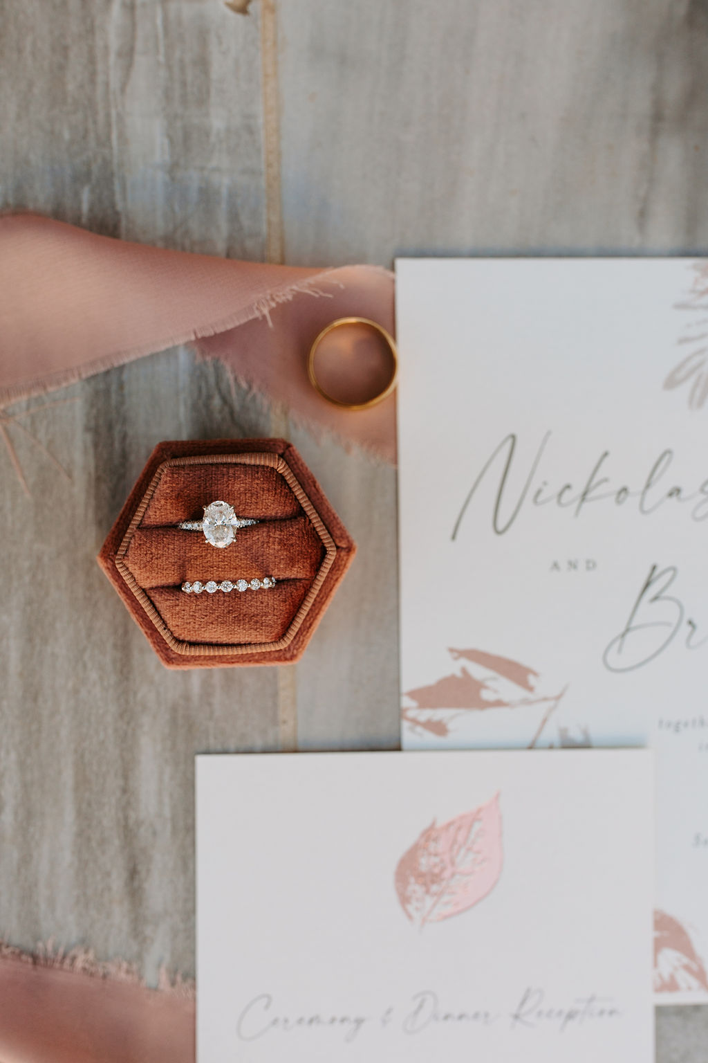 Wedding ring box and wedding invitations flat lay 