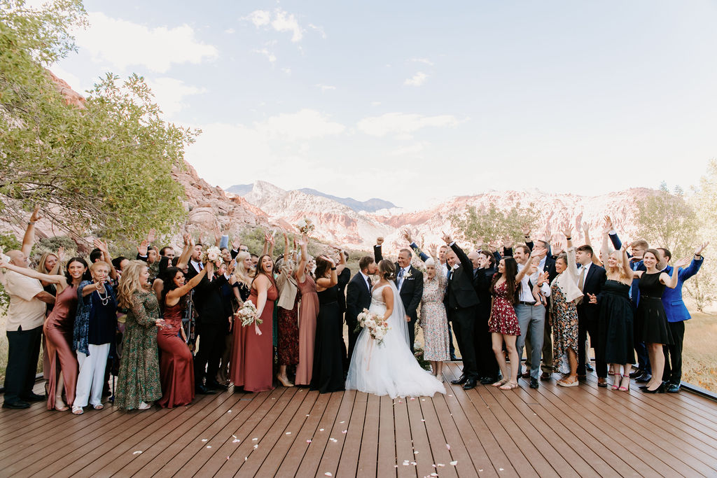Guests celebrating for group photo in Red Rock Canyon for Newlyweds 