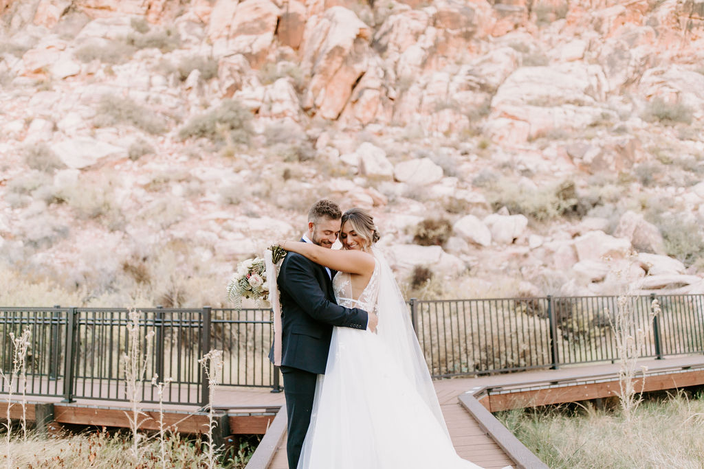 Bride and Groom hugging in Red Rock Canyon during Romantic Desert & Backyard Micro-Wedding