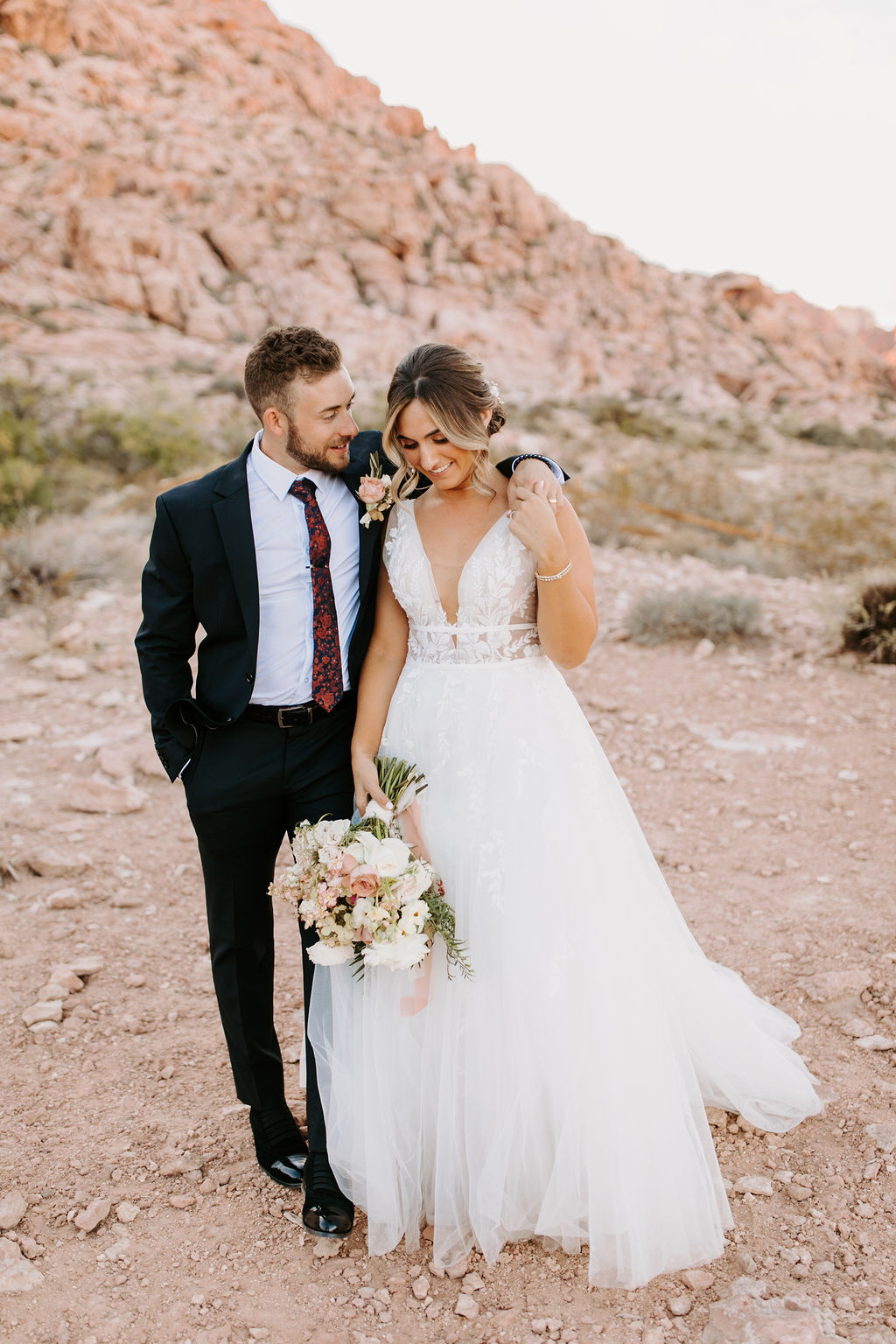 Bride and groom walking in Las Vegas desert 