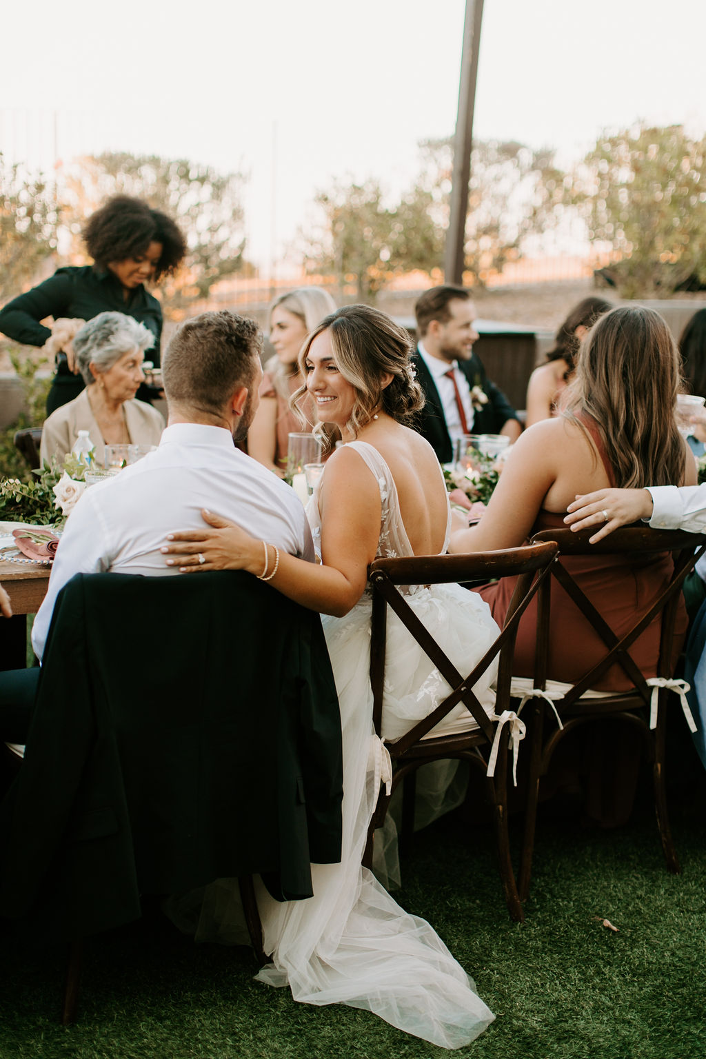 Bride and Groom sitting with guests Romantic Desert & Backyard Micro-Wedding