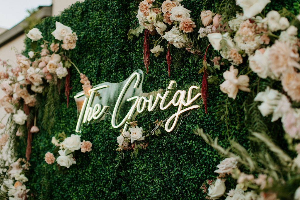 Green backdrop with soft pink florals and Neon Sign for Romantic Desert & Backyard Micro-Wedding