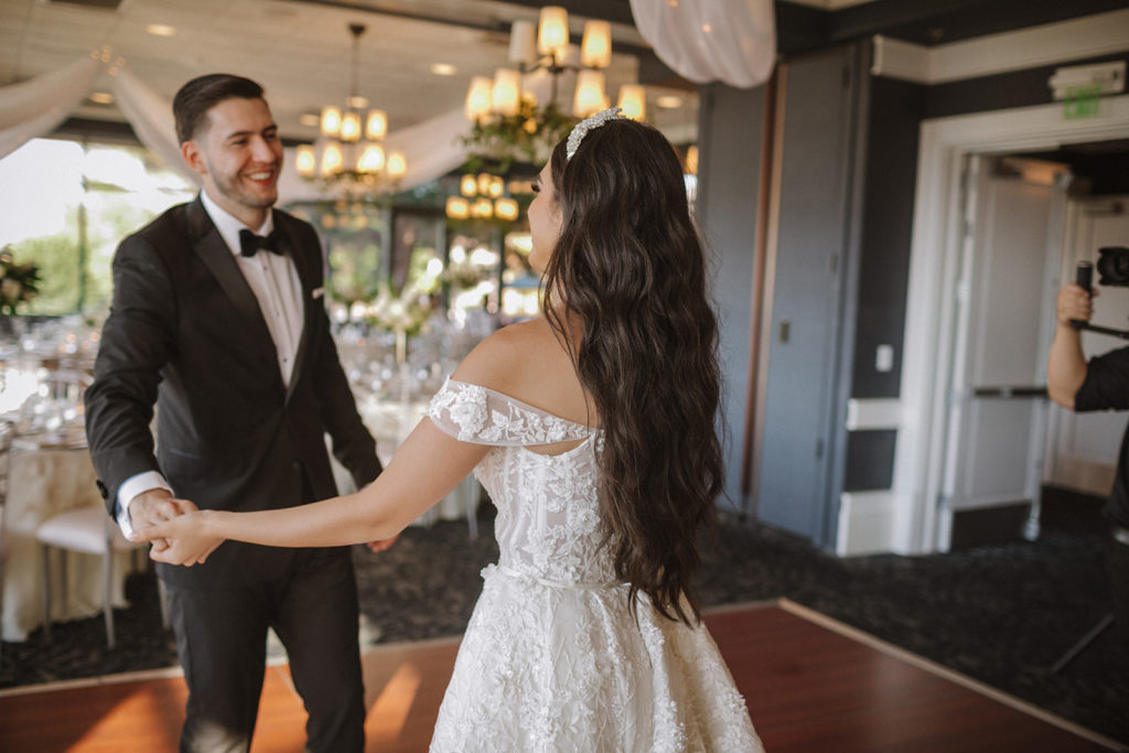 The Ultimate Wedding Timeline. Newlyweds doing a private first dance after having a room reveal of the reception. 