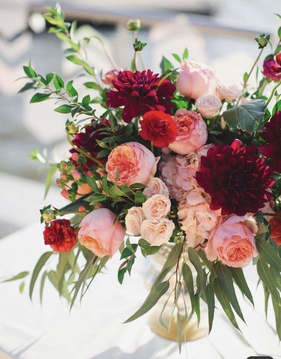 Magenta wedding bouquet paired with tons of greenery.