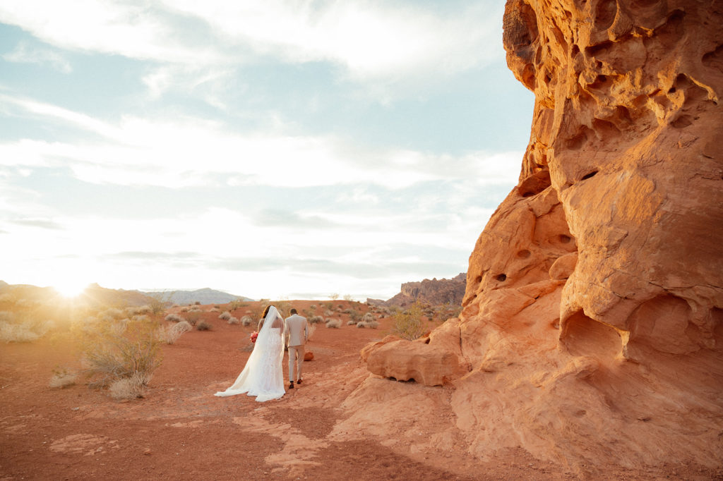Bold & Colorful in the Vegas Desert. Newlyweds walk into the sunset in the middle of the desert of valley of fire 