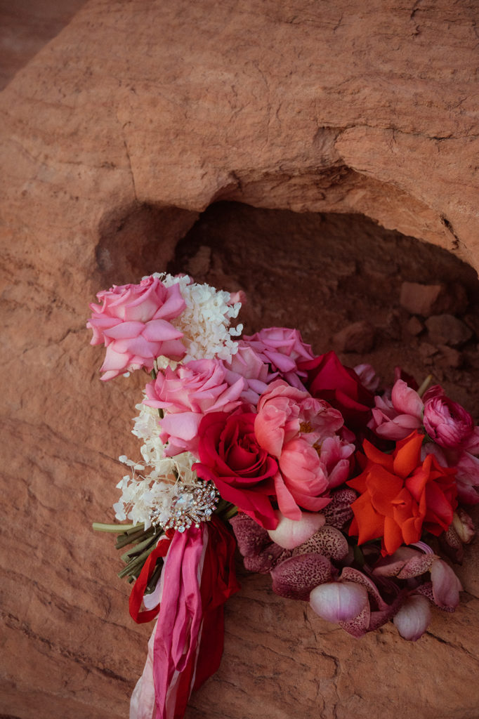 Bold & Colorful in the Vegas Desert. Up close photo of the brides monochromatic magenta bouquet with an array of flowers 