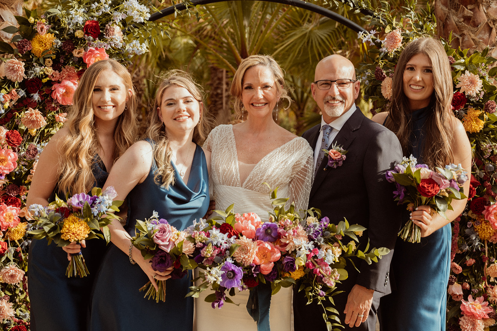 Bold Jewel Toned & Iconic Wedding Party and brides with their bouquets 