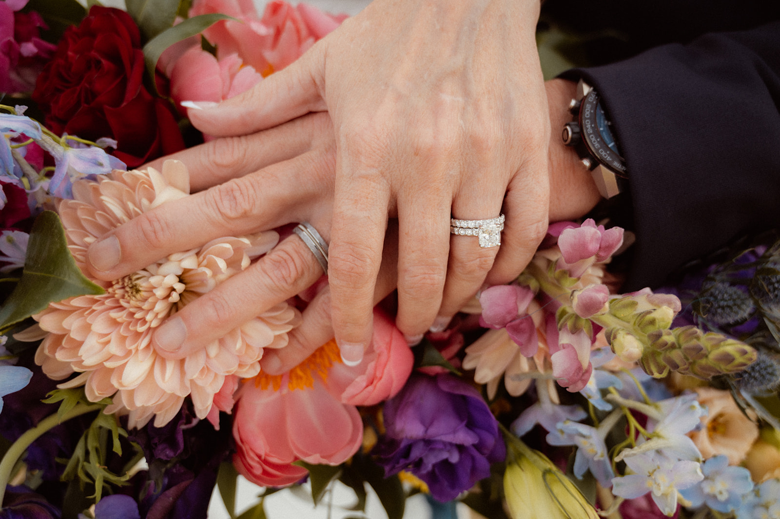 Hands with Wedding Rings on Bold Jewel Toned & Iconic Wedding Bouquet 