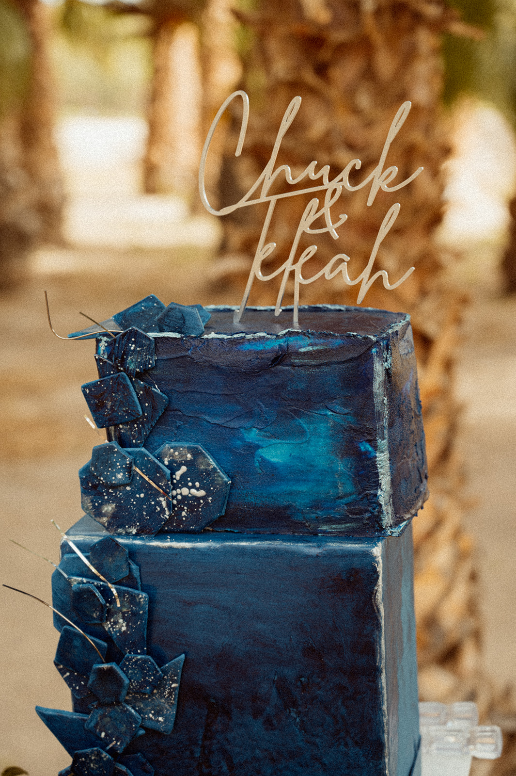 Jewel tone blue cake with wedding topper 