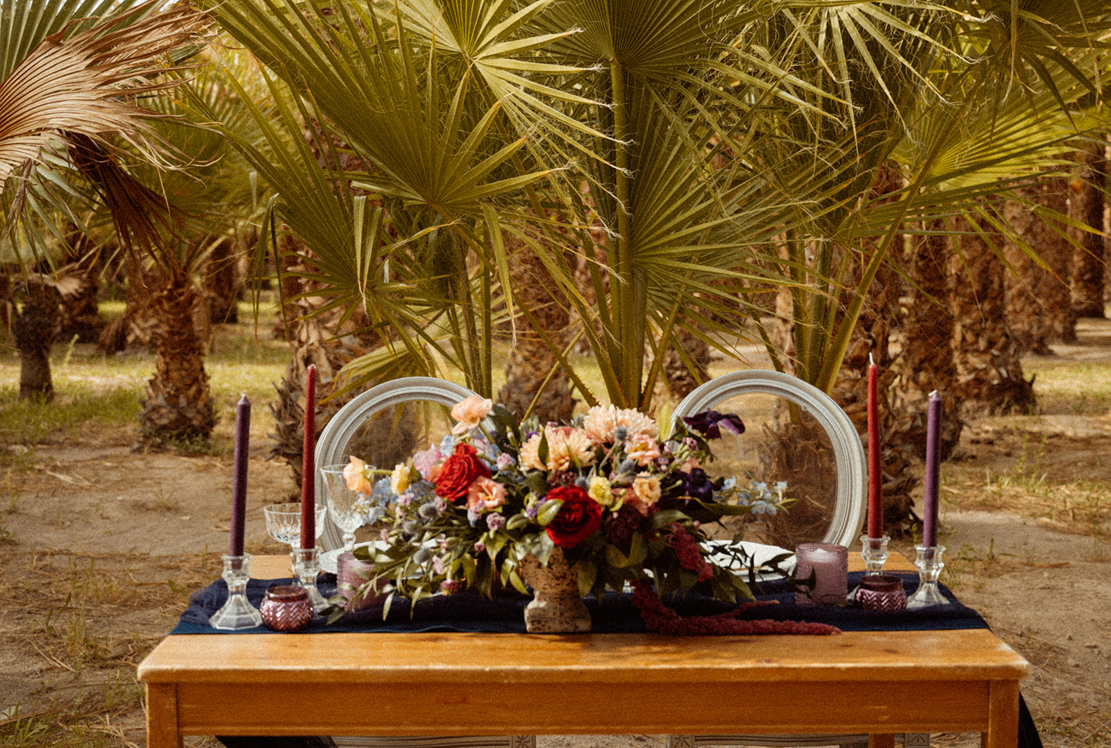 Bold Jewel Toned & Iconic Wedding Sweetheart table in palm tree oasis 