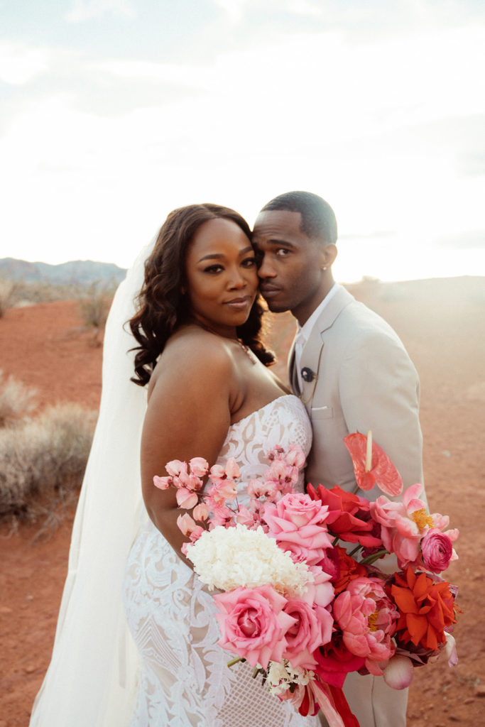 Viva Magenta Color Palettes. Bride and groom at Valley of Fire as bride holds a lush monochromatic magenta floral bouquet 