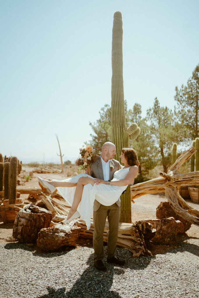 Grooming holding bride next to Cactus 
