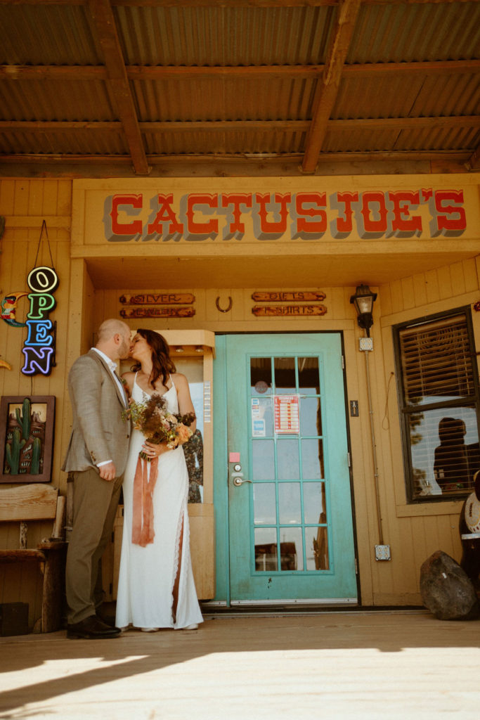 Newlyweds standong outside of Cactus Joe's Nursery entrance after Elopement