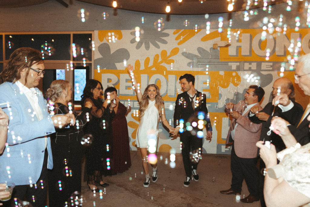 Grand exit ideas. Newlyweds run through a trail of bubbles from the guest as they leave the reception. 