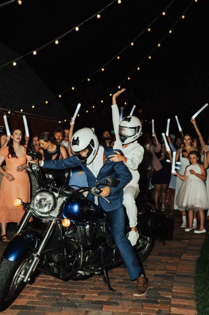The bride and groom get ready to take off on their motorcycle 