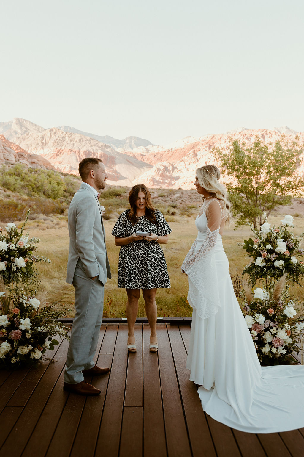 Red Rock Desert & Neon Vegas Lights. Bride and groom standing at the altar