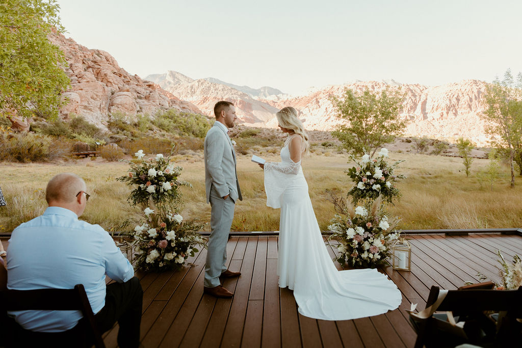 Red Rock Desert & Neon Vegas Lights. The bride reading her personal vows to the groom