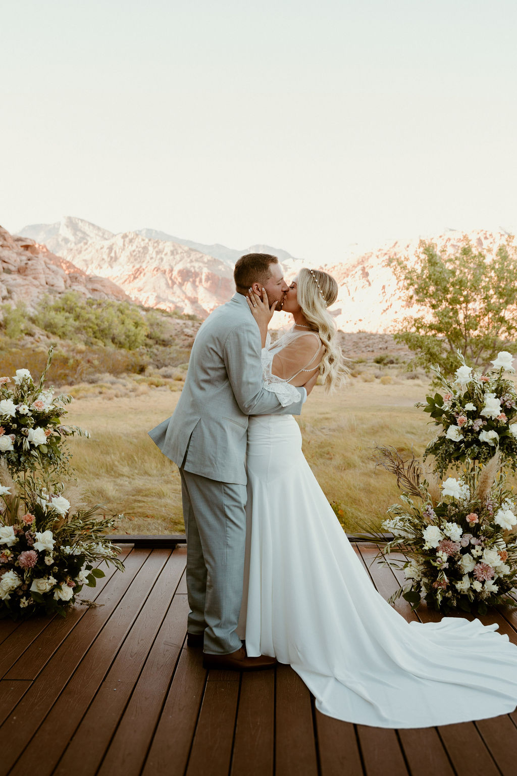 Red Rock Desert & Neon Vegas Lights. Newlyweds have their first kiss 