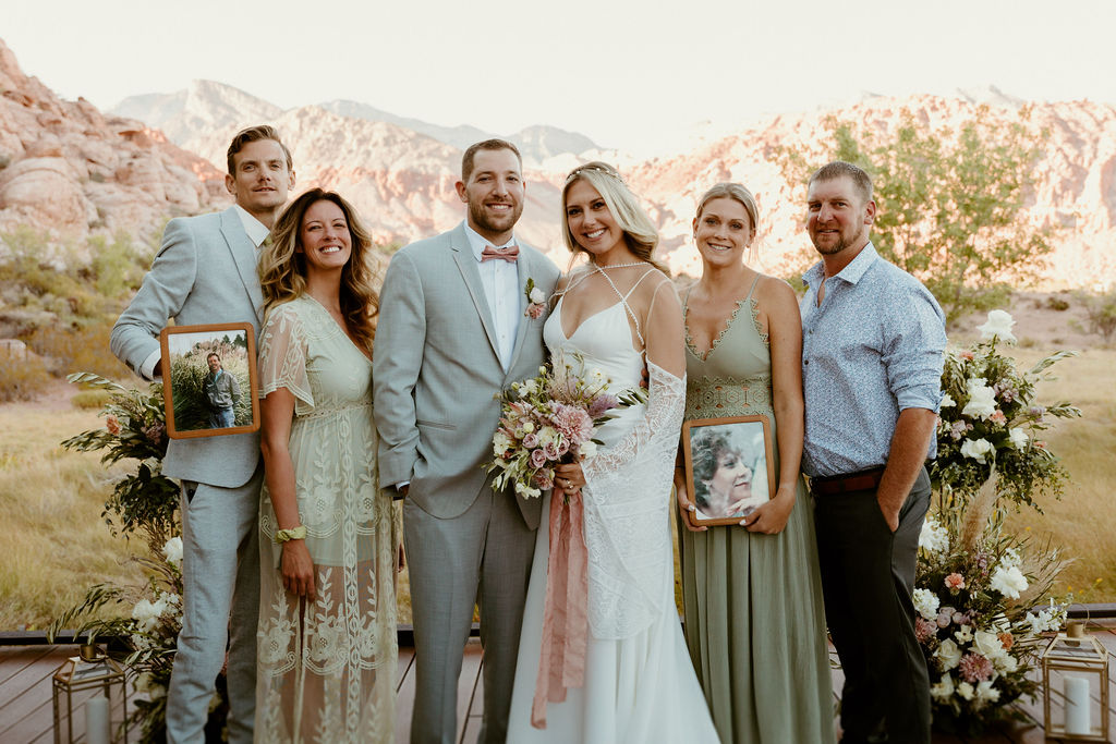 Red Rock Desert & Neon Vegas Lights. The bride and groom take a photo with the brides family