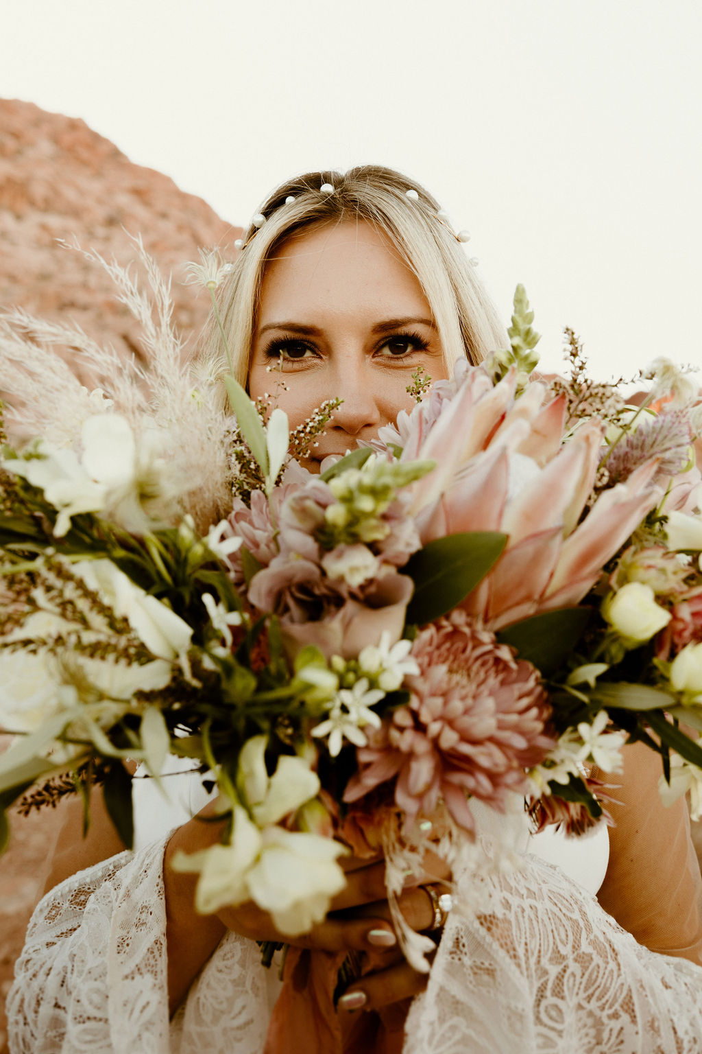 The brides mauve wedding bouquet with greenery and pampas grass 